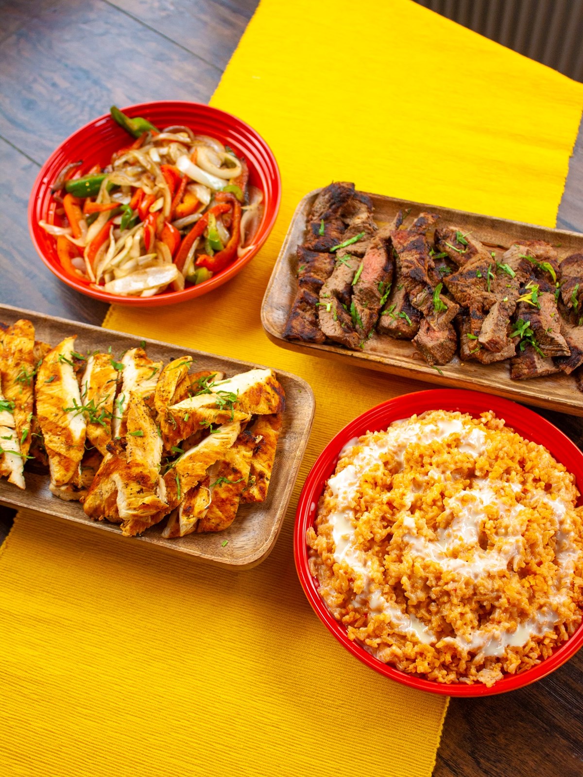 Que Onda catering arrangement with marinated chicken, grilled steak and veggies. 