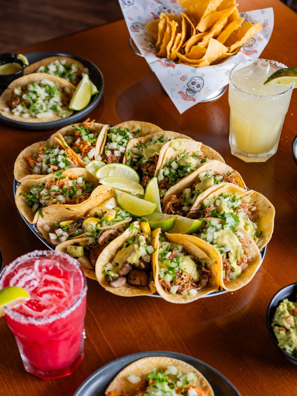 Delicious Que Onda tacos arranged on a platter. 